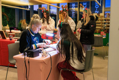 A girl gets sized for a bracelet by one of the vendors at the Merry and Bright event at Marywood University in Scranton, PA.