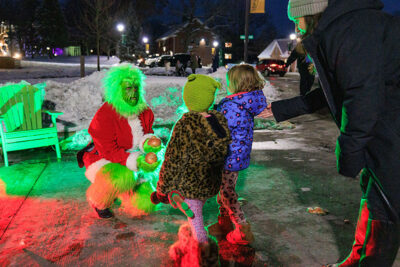 The grinch hands out onions to children during the Merry and Bright event at Marywood University in Scranton, PA.