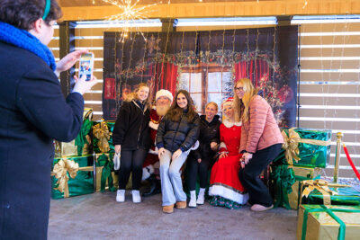 A group of students get their photo taken with Mr. and Mrs. Claus during the Merry and Bright event at Marywood University in Scranton, PA.