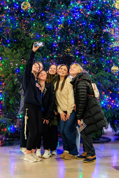 A group of students take a selfie in front of the Christmas Tree during the Merry and Bright event at Marywood University in Scranton, PA.