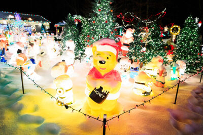 A Winnie the Pooh blow mold lights up in front of many other blow molds at the Saint Nick's Display in Waymart, PA.