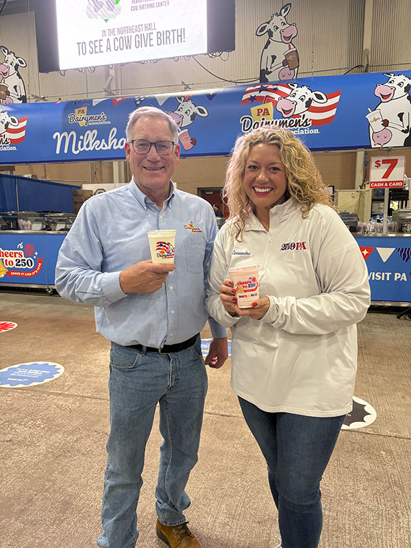 A man and a woman pose with their milkshakes at the PA Farm Show in Harrisburg, PA.