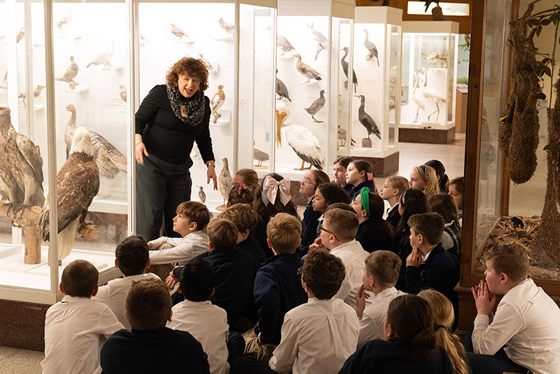 A group of children sit and listen to a museum educator at the Everhart Museum in Scranton, PA.