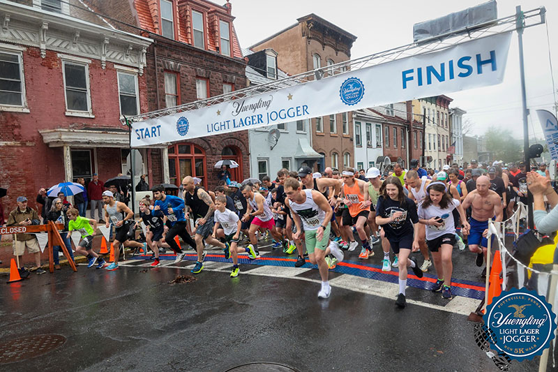 Runners take off from the starting line at Yuengling’s Light Lager Jogger race in Pottsville, Pennsylvania.