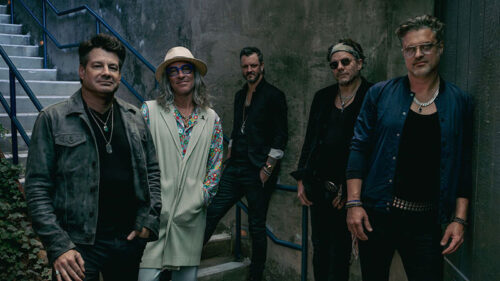 Band members of Collective Soul standing together in an outdoor setting, appearing live at the F.M. Kirby Center in Wilkes-Barre, PA.