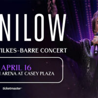 Barry Manilow The Last Wilkes-Barre Concert spring concert at Mohegan Arena at Casey Plaza in Wilkes-Barre Twp. on April 16, 2026, featuring Barry Manilow performing on stage. Text on image reads: “Manilow,” “The Last Wilkes-Barre Concert,” “April 16,” and “Mohegan Arena at Casey Plaza.”