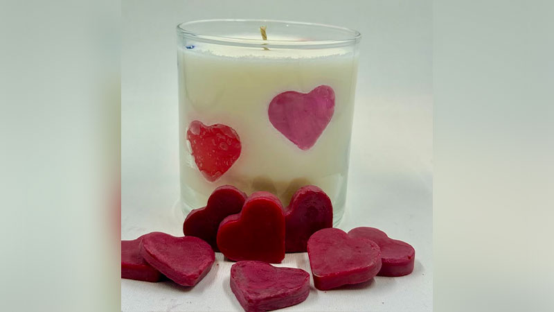 A candle with wax hearts on display for the Galentines Day Candle Workshop at the Back Mountain Makery in Dallas, PA.