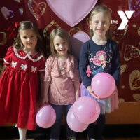 Sweetheart Valentine Dance at Greater Scranton YMCA in Scranton, PA with three girls holding Valentine balloons.