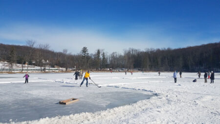Skaters and hockey players out on the ice on Eston Wilson Lake at Hillside Park in South Abington Twp., PA.