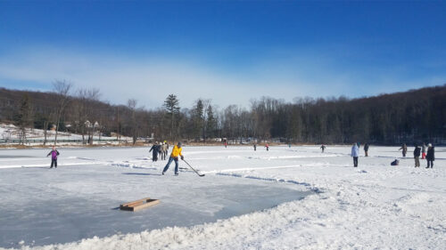 Skaters and hockey players out on the ice on Eston Wilson Lake at Hillside Park in South Abington Twp., PA.