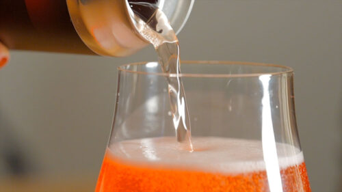 A can of Grandad's Cranberry Cream Ale being poured into a glass