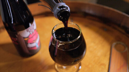 Devil's well pouring from a bottle into a glass