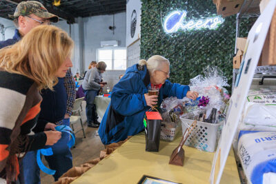 A woman looks through the raffle baskets during the Shiverfest after party at Groove Brewing in Scranton, PA.