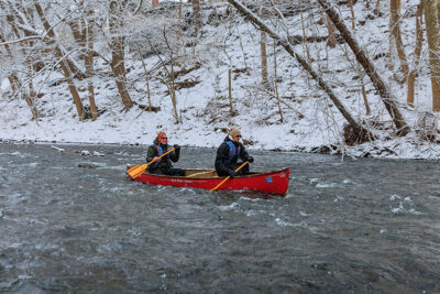 A father and son take on some rapids in their canoe during Shiverfest in Scranton, PA.