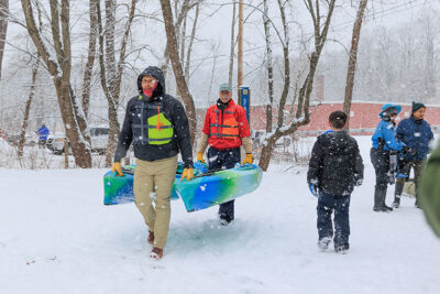 Kayakers carry their boats to the Lackawanna River during Shiverfest in Scranton, PA.