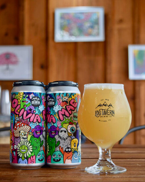 Two cans of beer and a fresh beer in a glass on the bar at Log Tavern Brewing Company in Milford, PA.