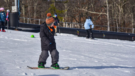 A young boy snowboards at Ski Big Bear in Lackawaxen, PA.