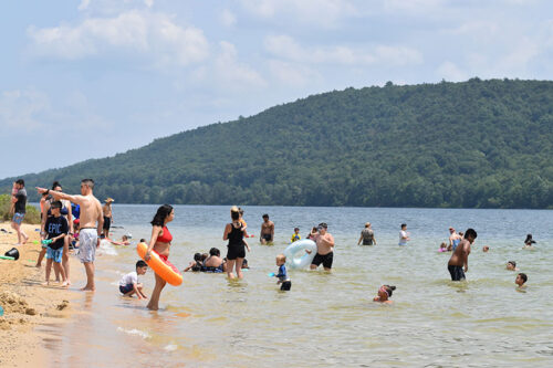 Visitors enjoy the sandy beach during the summer at Beltzville State Park in Lehighton, PA.