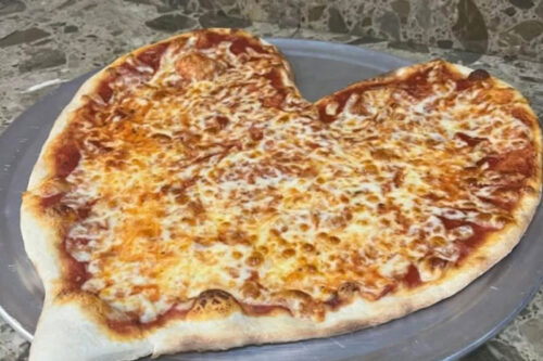 A heart shaped pizza rests on a pizza trey at Alta Pizzeria in Hazleton, PA.