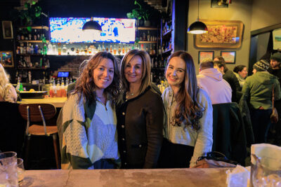 Three women stand together in front of a bar posing for a photo during Celebrate Music in Pittston, PA.