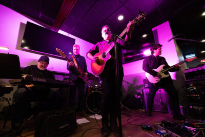 A band performs on stage with guitar, keyboard and drums during Celebrate Music in Pittston, PA.