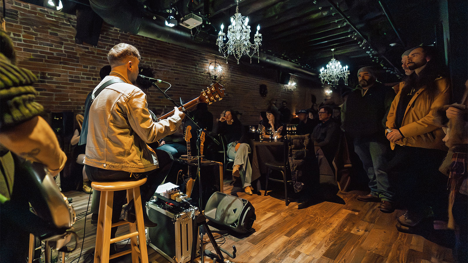 An audience watches a solo musician perform on a small stage during Celebrate Music in Pittston, PA.