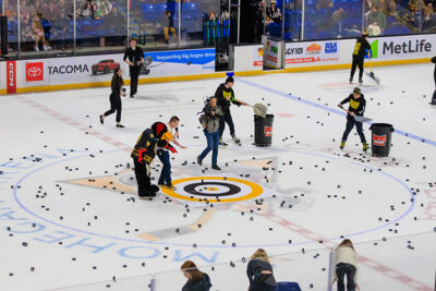 The clean up crew clears the ice of hockey pucks thrown by the crowd the WIlkes-Barre/Scranton Penguins game in Wilkes-Barre, PA.