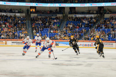 Hockey players chase the puck at the WIlkes-Barre/Scranton Penguins game in Wilkes-Barre, PA.