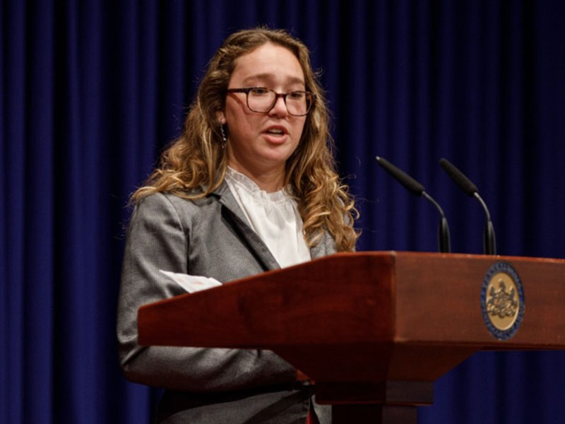 A young woman delivers a speech during the A250PA Direct Effect Challenge.
