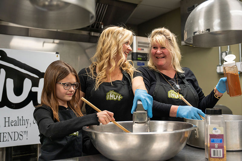 Daughter, mom and grandma prepare meals in the commercial kitchen at Hazleton Kitchen Incubator in Hazleton, PA. 