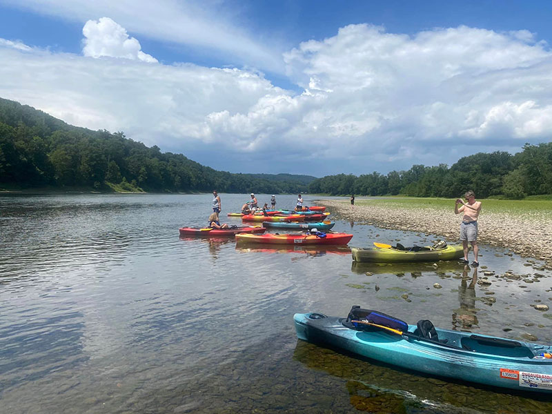 A group of kayakers launches from a beach on the Susquehanna River in Falls, PA.