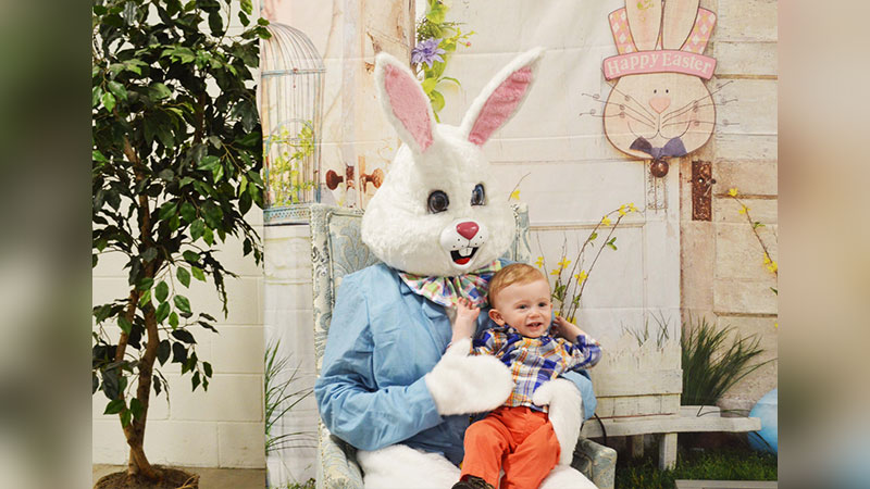 The Easter Bunny holding a small boy to promote the Easter Bunny Brunch Buffet & Egg Hunt at Pocono Organics in Long Pond, PA.