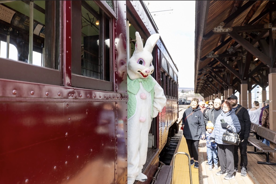The Easter Bunny standing in the entrance greeting guests as they board the Easter Bunny on the Trolley excursion in Scranton, PA.