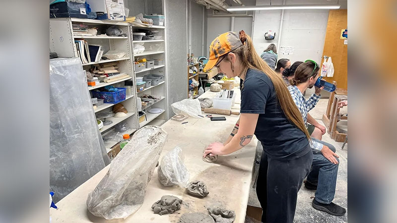 A women preparing her clay for the Throwdown with Joni Mazzie at the Hazleton Art League in Hazleton, PA.