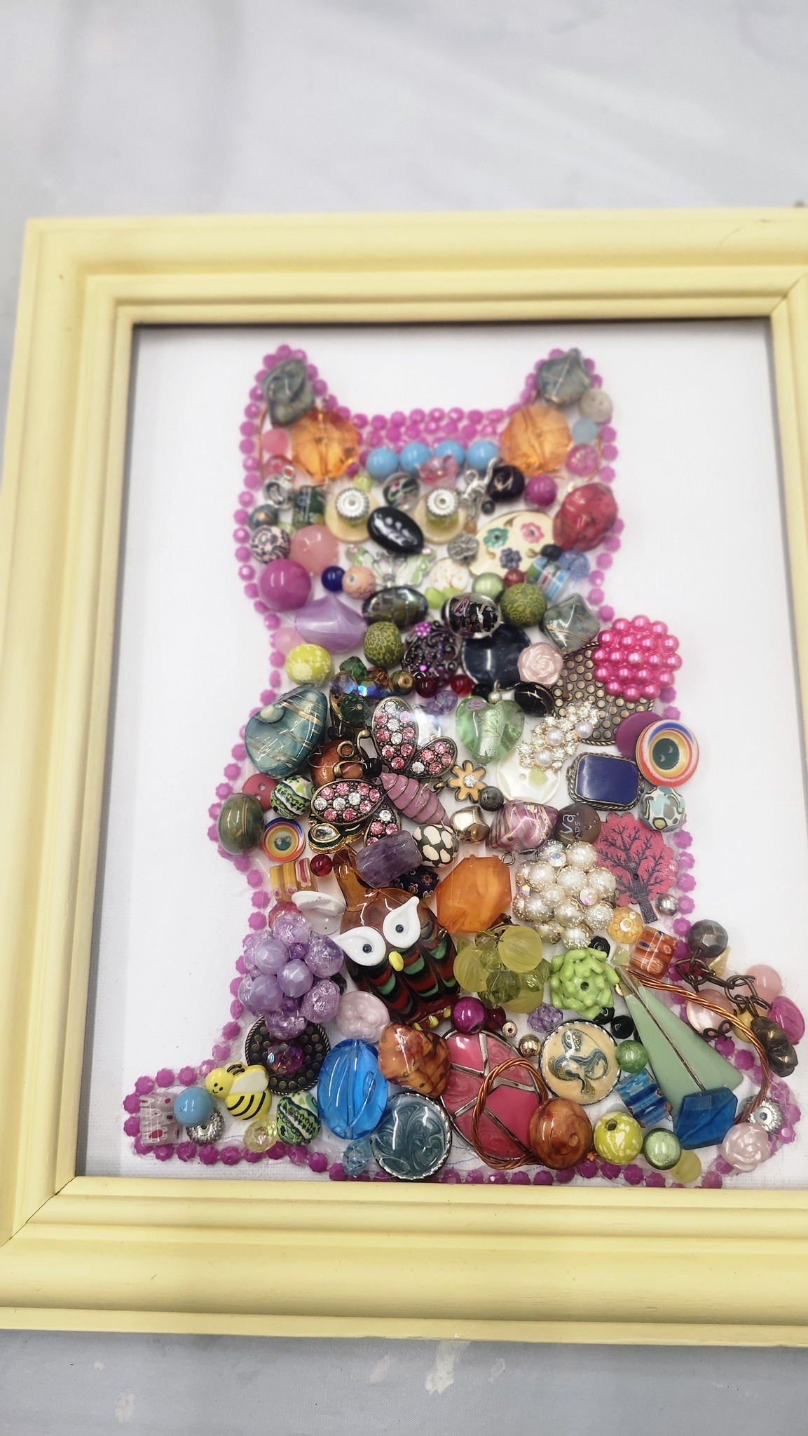 A framed art piece made of vintage jewelry from the Crooked Branch in West Pittston, PA