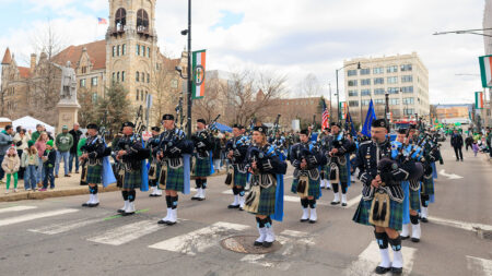 A group of bagpipers march their way down the street during the St. Patrick's Day parade in Scranton, PA.