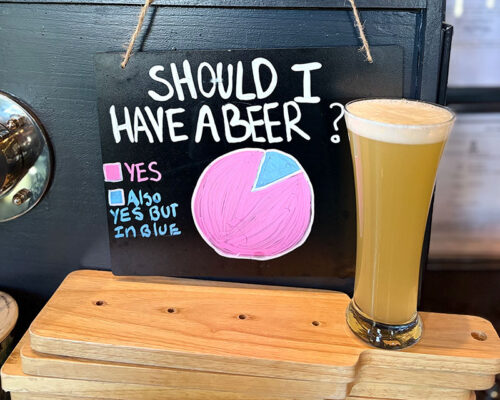 A tall pint of hazy beer on the bar at Hairy Guys Brewing in Jim Thorpe, PA.