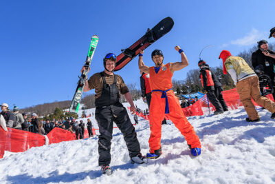 A Skier and snowboarder raise their gear and flex for the camera at Mountainfest at Montage Mountain in Moosic, PA.