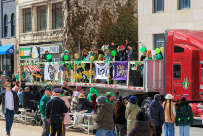 A bunch of party-goes dance on the back of a flatbed truck during the St. Patrick's Day parade in Scranton, PA.