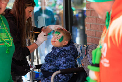 A boy gets his face painted during the St. Patrick's Day parade in Scranton, PA.