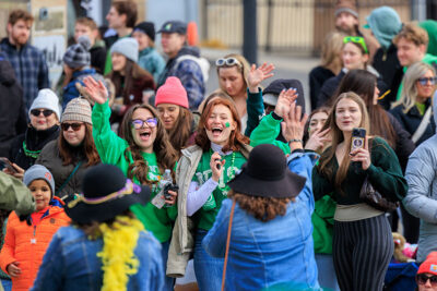A group of girls wave to thier friends during the St. Patrick's Day parade in Scranton, PA.