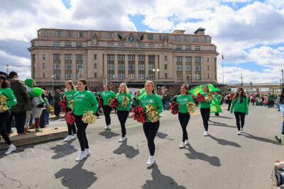 A group of local cheerleaders march their way down the street in front of the Radisson Hotel during Scranton's St. Patrick's Day parade.