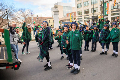 A group of Irish dancers wave to the camera during Scranton's St. Patrick's Day parade.