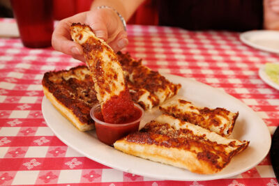 A cheesy breadstick gets dipped in marinara sauce at Pizza Hut Classic in Tunkhannock, PA.