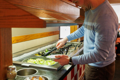 A man fills his plate at a salad bar inside Pizza Hut Classic in Tunkhannock, PA.