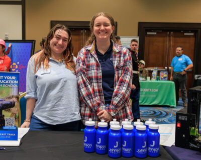 Two representatives from Johnson College smile for a photo during a career exploration event at the Mohegan Pennsylvania Convention Center in Wilkes-Barre, PA.