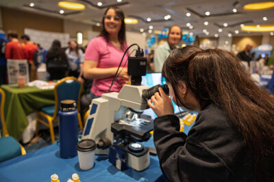 A students looks through a microscope during a career exploration event at the Mohegan Pennsylvania Convention Center in Wilkes-Barre, PA.
