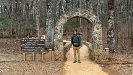 A hiker stands at the entrance of the Appalachian Trail on Spring Mountain in Georgia.