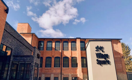 Exterior of The Lofts at Village Square apartment building in Scranton, PA, an example of adaptive reuse development.